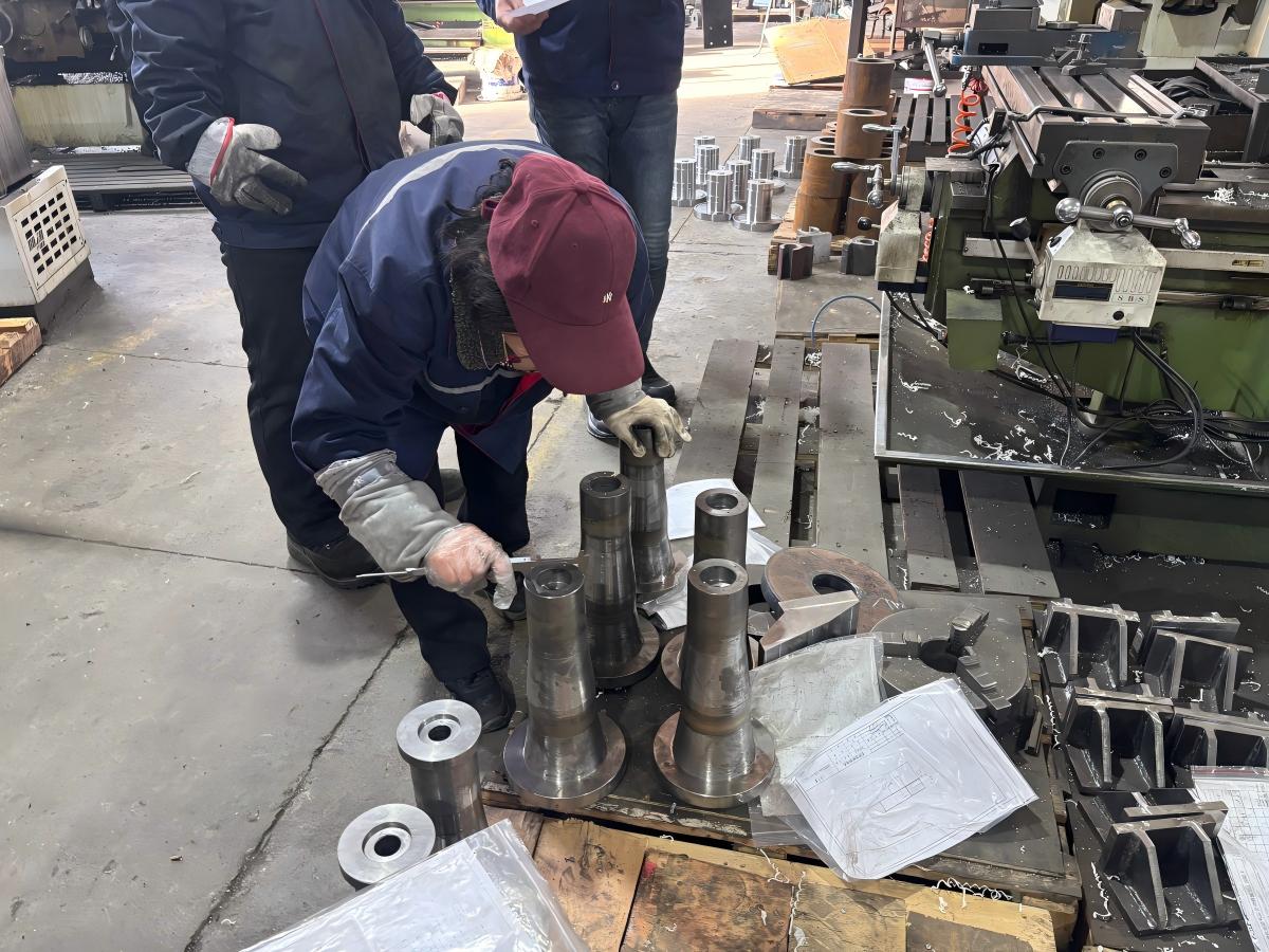 Capital Planning: Buying Industrial Equipment - Cash Vs. Financing? Manufacturing technician performing a structural integrity and dimensional accuracy check on a critical machine base component in a factory