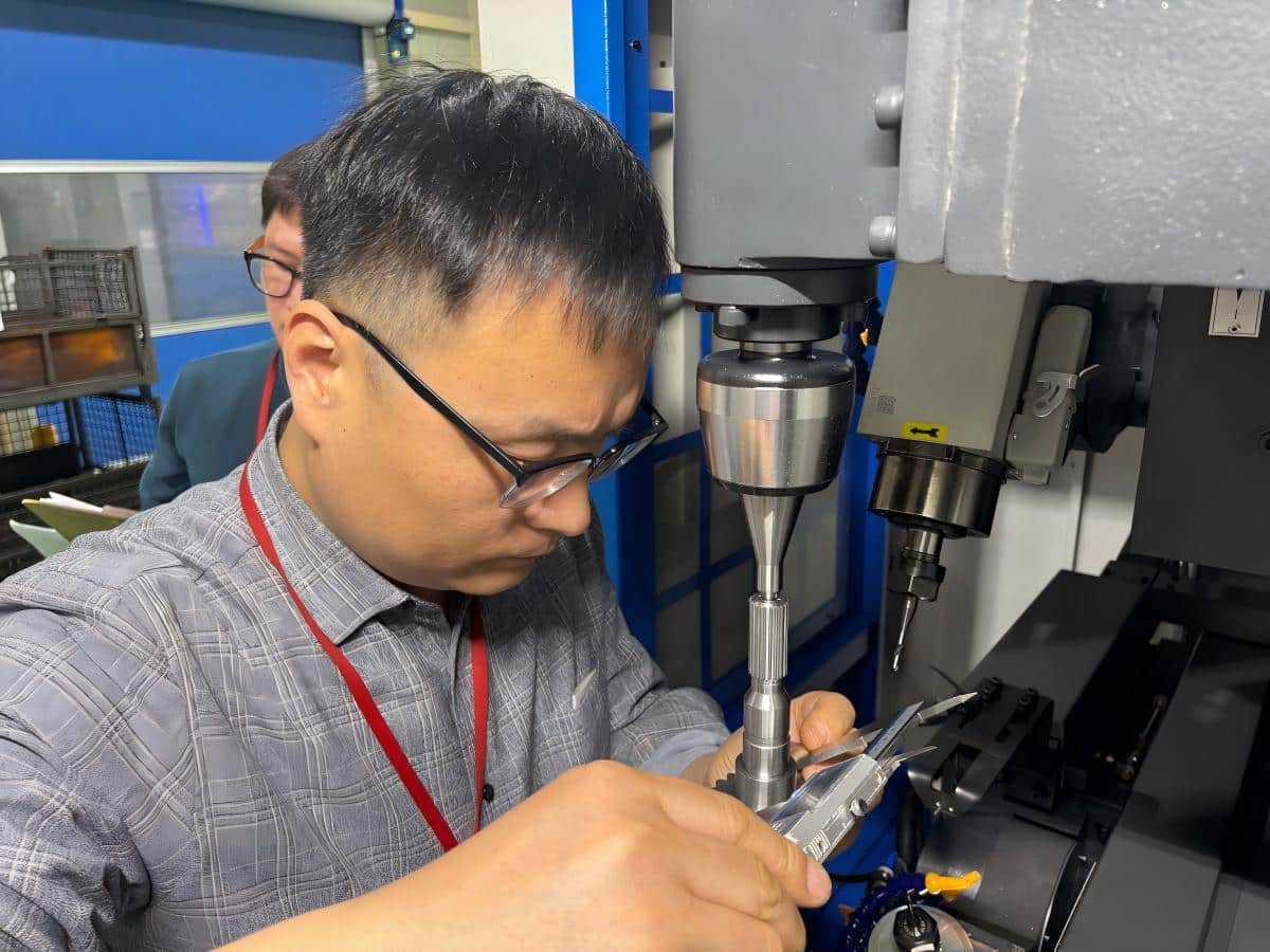 Seamless Line Integration: How To Connect Tube Lasers With Chamfering Machines Engineers conducting on-site precision inspection and accuracy testing of an gear chamfering machine using specialized measurement tools.